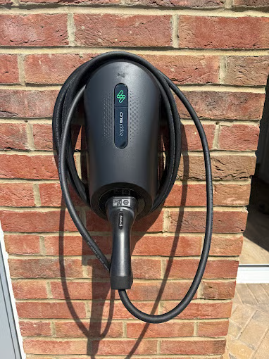 Ohme EV charger mounted on a brick wall by Earthbound Electrical
